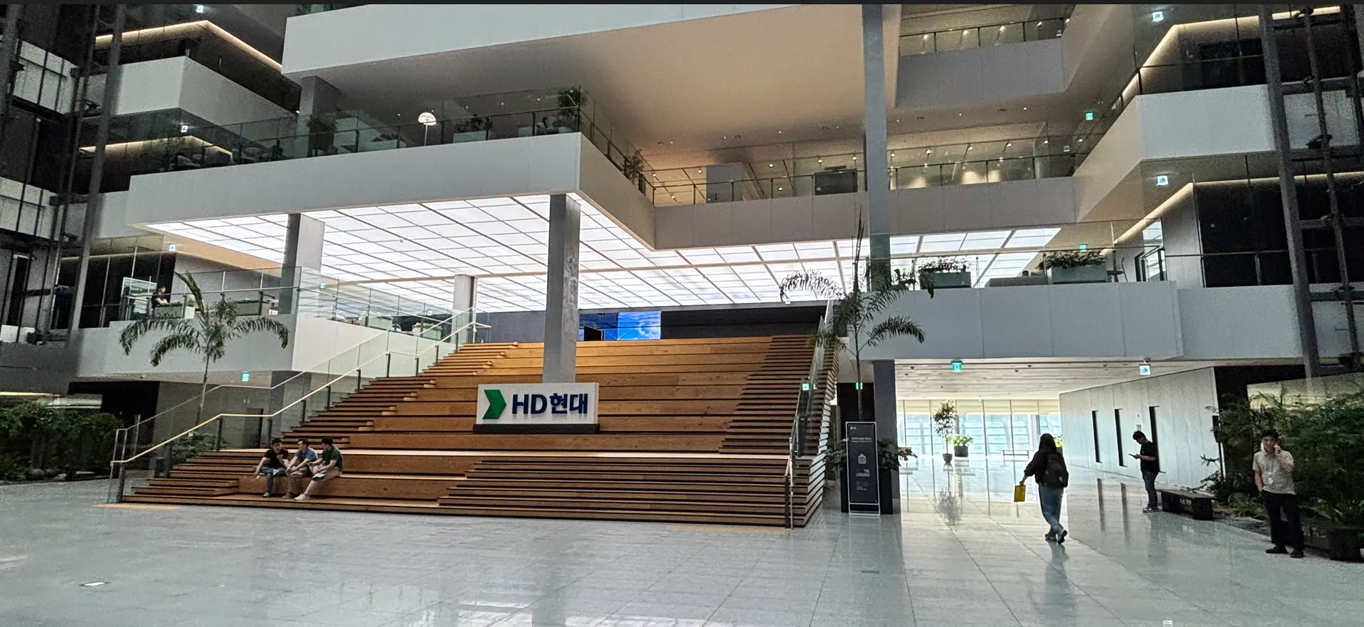 HD Hyundai Electric headquarters atrium with open staircase seating in South Korea